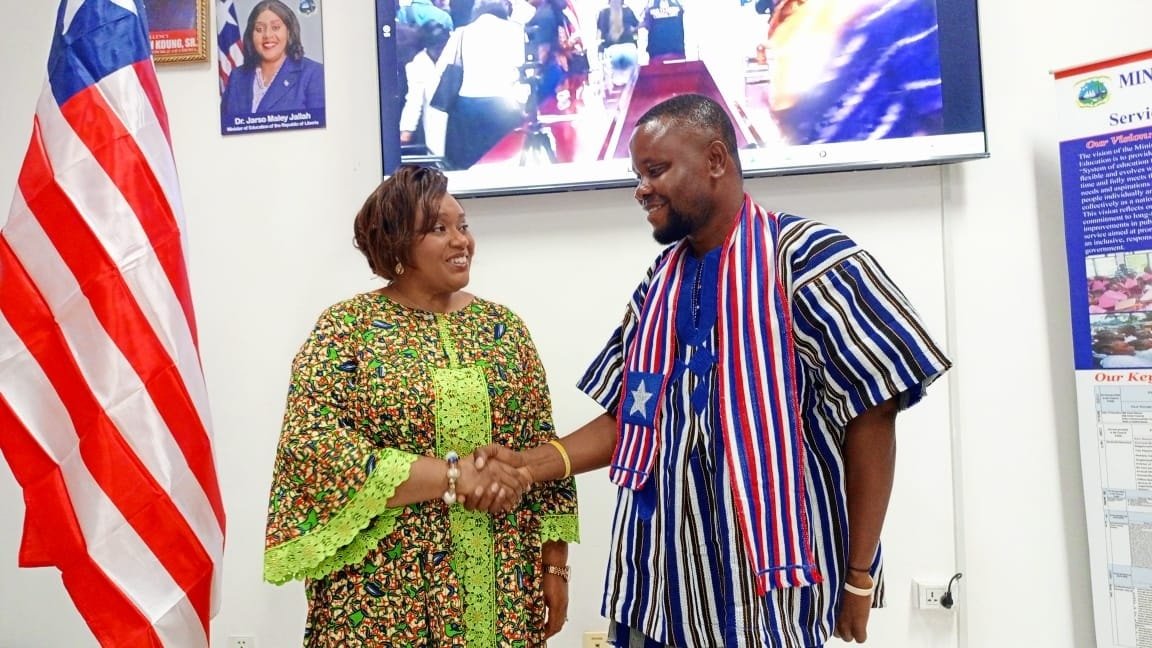 Minister Dr. Jarso Maley Jallah (left) honors teacher Allen A. Thomas